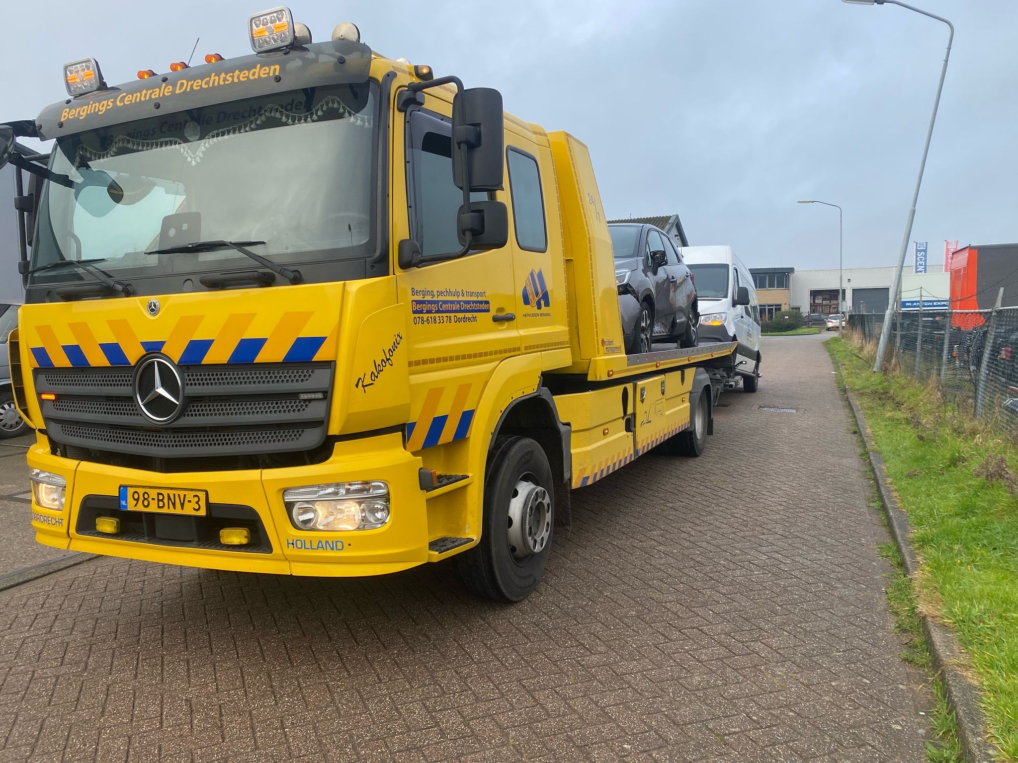 Truck met auto en bus